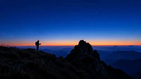 Hiker Beside Dark Rock Outcrop