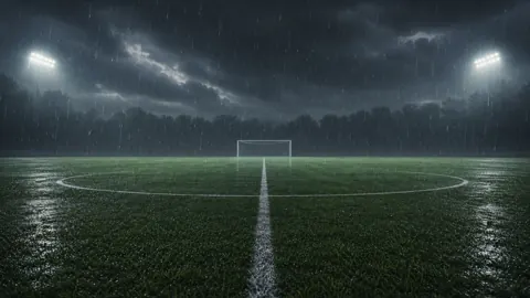 Rainy Soccer Field at Night
