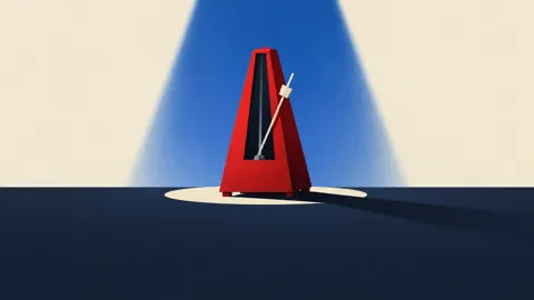 Red Metronome Under Blue Spotlight