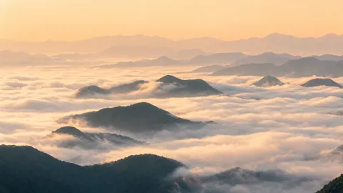 Mountain Ridges Above Clouds