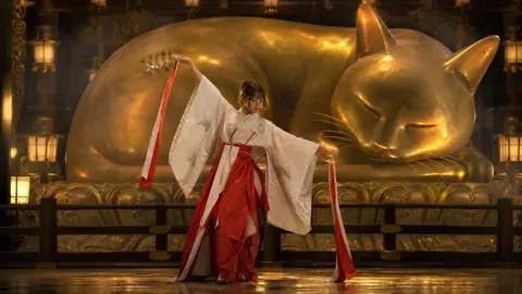 Shrine Maiden Dancing Before Gold Cat