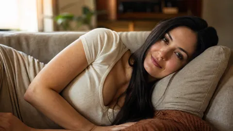 Woman on Beige Sofa