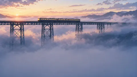 Commuter Train Above Sea Fog